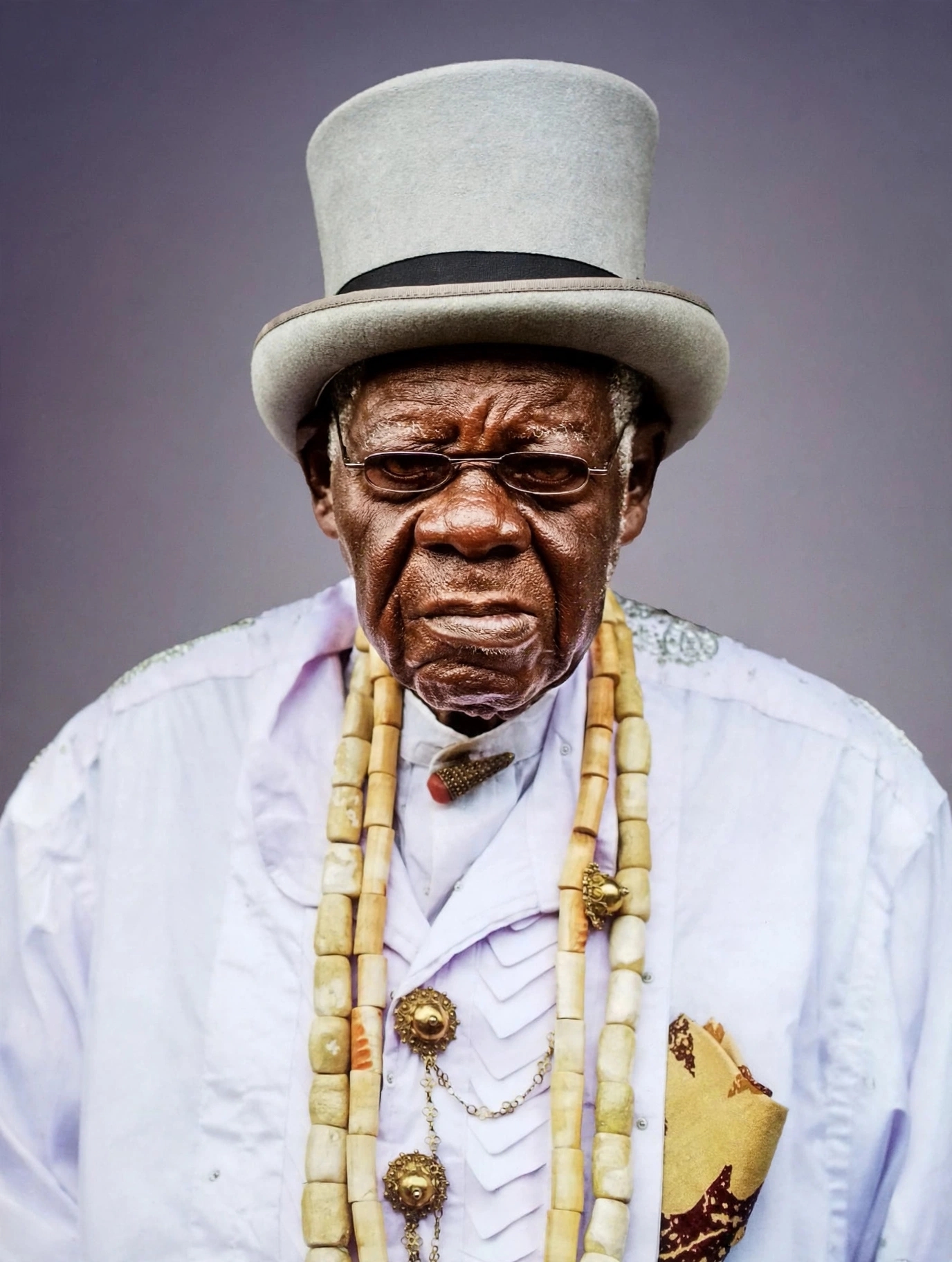 Late Chief Hans Suku-Ogbari Ogbari XII in red traditional Ijaw attire with black bow tie and white pom-pom cap, University of Lagos Electrical Engineering graduate